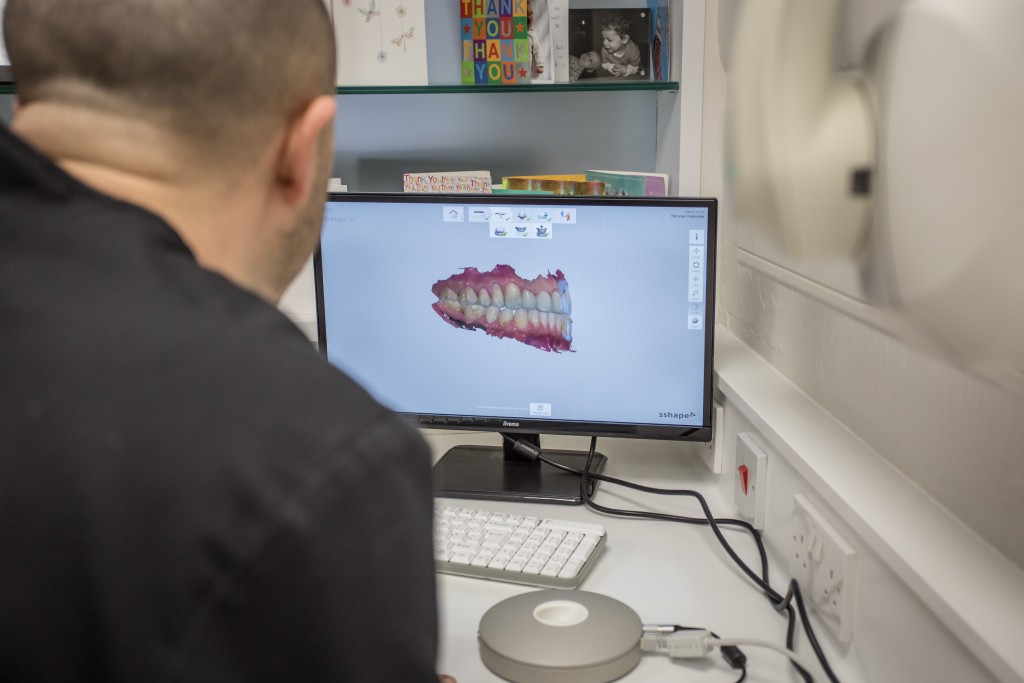 The Courtyard's Marcos White preparing a 3D scan of what a patient's mouth will look like after the completed veneers treatment