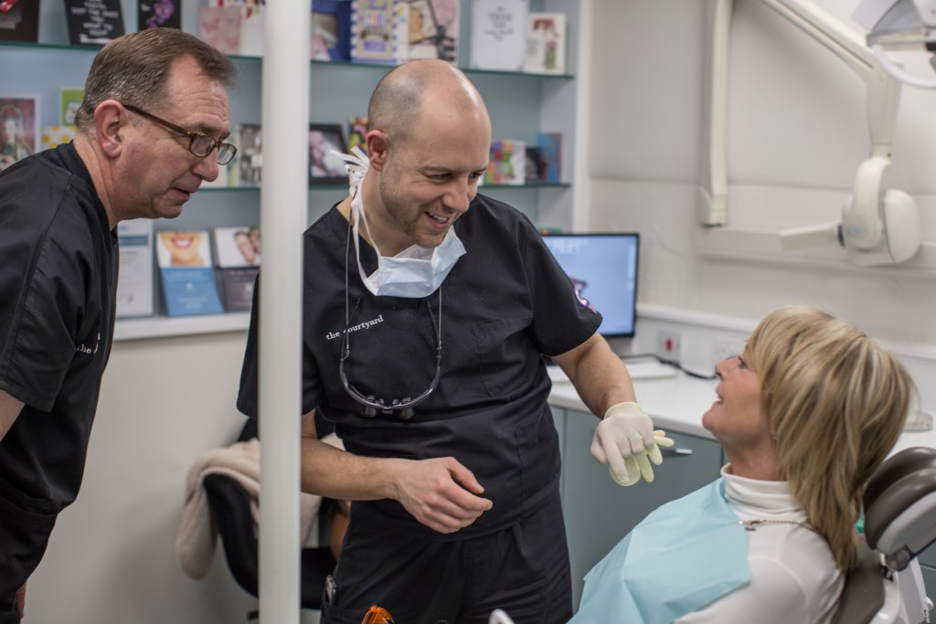 The Courtyard's Bernard and Marcos checking the results of a patient's veneers treatment